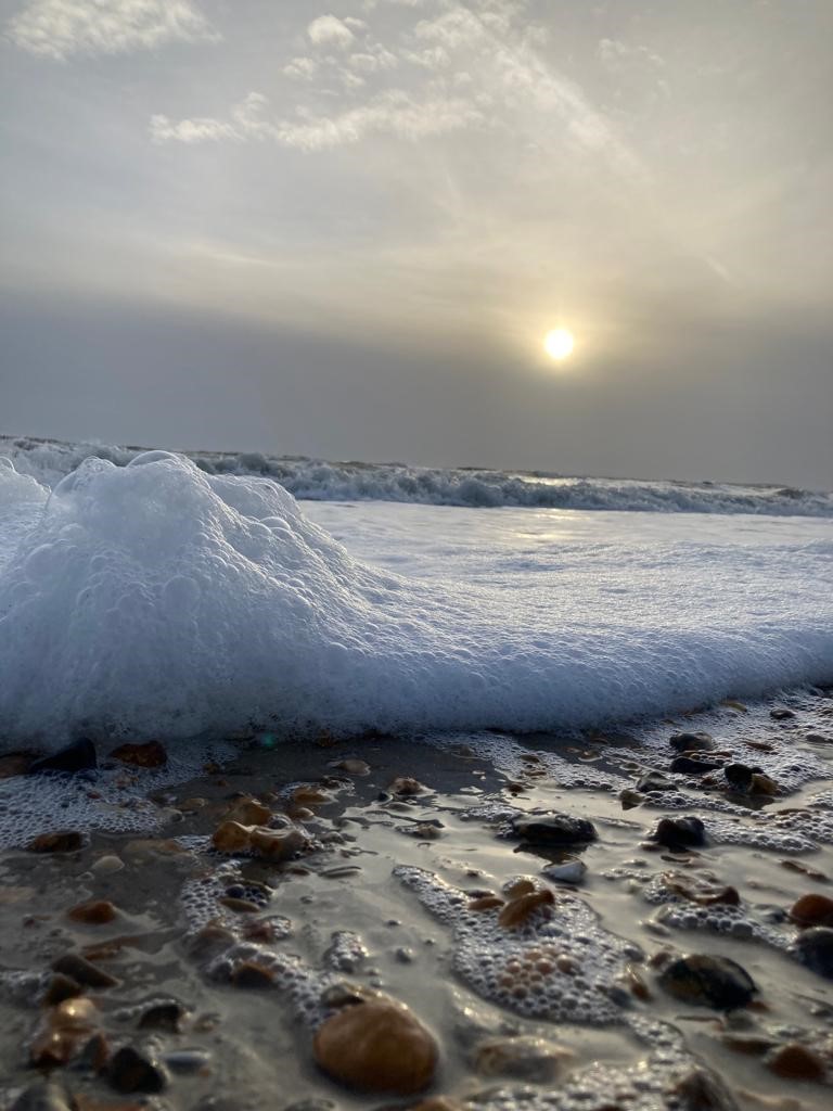 Wave coming in on beach at Barton on Sea